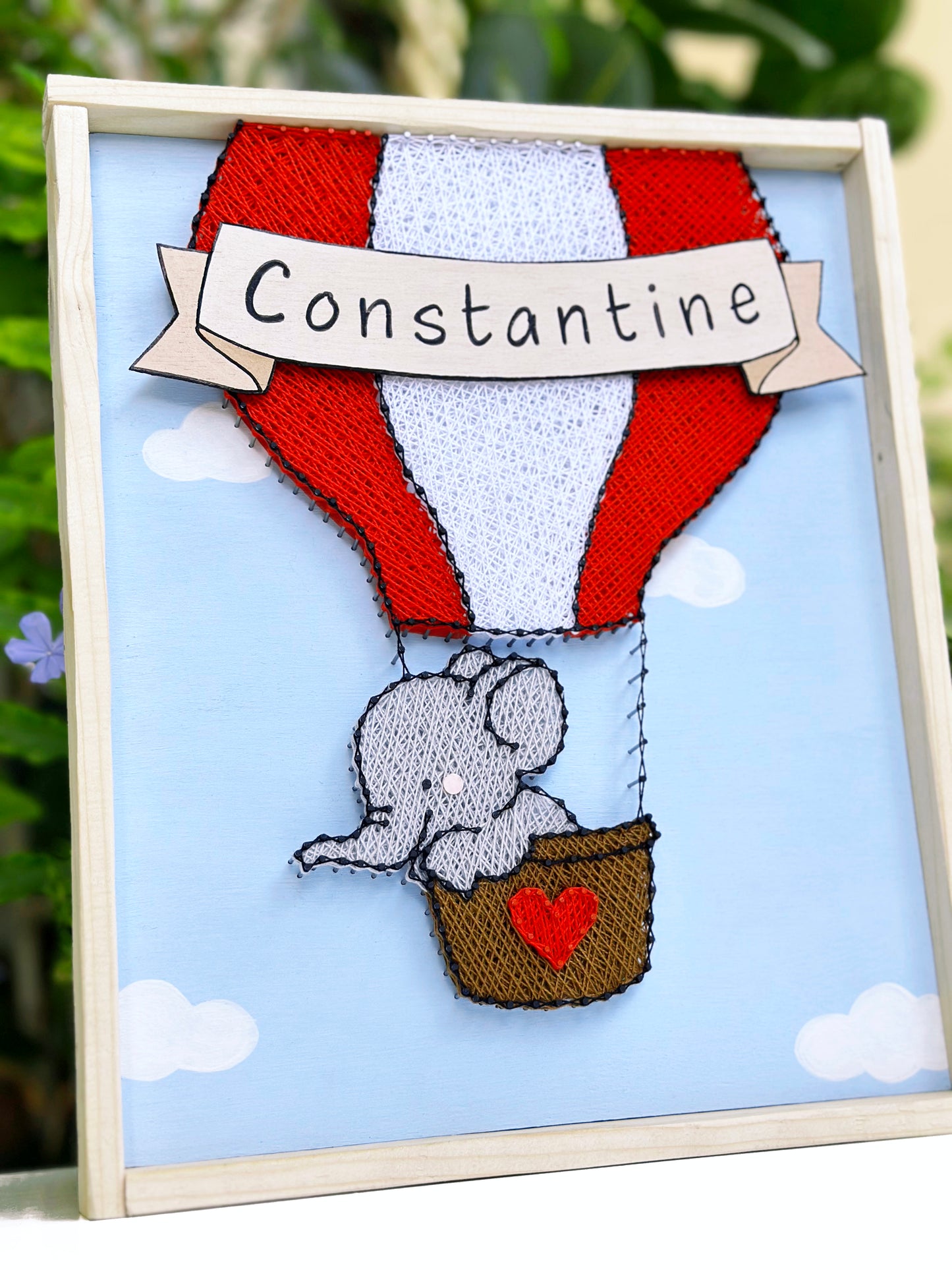 Little elephant on a red hot-air balloon