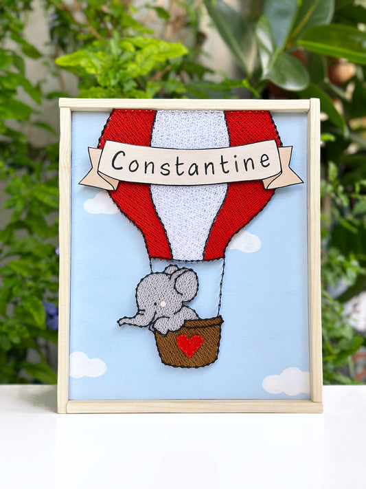 Little elephant on a red hot-air balloon